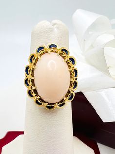 Beautiful 14K Yellow Gold Pink Coral & Blue Enamel Vintage Ring size 4.75 A perfect gift for your loved one for any special occasion or holiday! Total Ring Weight: 6.32g Ring Length: 27.05mm Ring Width: 17.88mm Gemstone: Pink Coral, Blue Enamel Item will be placed into a gift box. * Oval 14k Gold Enamel Ring Gift, Oval 14k Gold Enamel Gift Ring, Luxury Oval Enamel Ring For Gifts, Cabochon Sapphire Ring Fine Jewelry Gift, Cabochon Sapphire Ring Gift, Elegant Blue Oval Enamel Ring, Heirloom Style Formal Enamel Ring, Yellow Gold Oval Enamel Ring For Gift, Oval Yellow Gold Enamel Ring For Gift