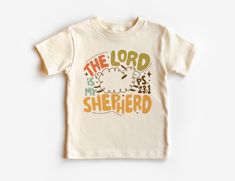 The Lord Is My Shepherd Toddler Shirt - Cute Sheep Christian Kids Clothing - Psalms 23 Bible Verse - Boho Natural Toddler & Youth Tee If you love super soft, lightweight, extremely comfy shirts and baby bodysuits then you will absolutely love our unisex kids shirts and baby bodysuits! These shirts are hand printed with a professional garment printer for a soft, durable, long lasting, printed graphic using high quality water based inks. * The printed design is very soft to the touch due to our pr Kids Christian Shirts, Christian Kids Shirts, Psalms 23, Christian Shirts Designs, The Lord Is My Shepherd, Christian Kids, Cute Sheep, Shirt Design Inspiration, Psalm 23