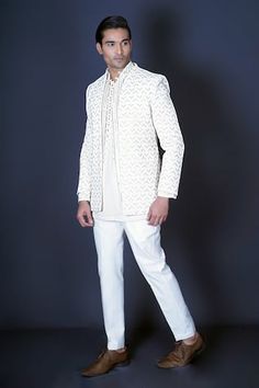 Ivory jacket with geometric pattern stone hand embroidery. Comes with bundi style vest with gold mirror and gota work, and an ivory kurta with embroidered with self on self thread work. Paired with a pant. - Aza Fashions Traditional Long Sleeve Sherwani With Geometric Embroidery, White Traditional Wear With Pearl Embroidery And Long Sleeves, Festive Sherwani With Geometric Embroidery, White Traditional Long Sleeve Wear With Pearl Embroidery, Festive White Kurta With Geometric Embroidery, Festive Sherwani With Geometric Embroidery And Long Sleeves, Festive Long Sleeve Sherwani With Geometric Embroidery, White Sets With Geometric Embroidery For Festive Occasions, White Festive Sets With Geometric Embroidery