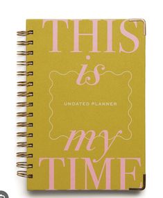 this is an undated planner with pink lettering on the front and yellow back cover