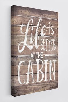 a wooden sign that says life is better at the cabin