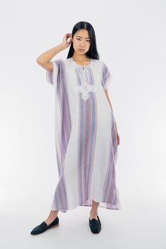 This cotton Kaftan has a particular stripy pattern and a rich white embroidery that makes it so unique in its style. To be worn from your grocery shopping trip, to chilled evenings at home, this kaftan is an essential for the summer! 100% cotton One size  Bust: 28 in Length: 50 in Model is 5'7 in (174 cm) Casual White Short Sleeve Kaftan, Striped Kaftan For Spring Vacation, Summer Short Sleeve Cotton Kaftan, White Vertical Stripes Dress For Daywear, White Long Kurta For Beach, Long White Kurta For Vacation, Bohemian Striped Kaftan For Summer, Striped Kaftan For Summer Vacation, White Cotton Tunic Kaftan