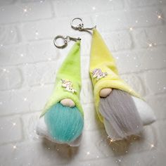 two keychains with different colored hair on them