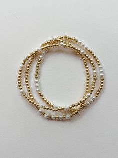 these super sweet and dainty gold and pearl bracelets are perfect for everyday wear! each one is custom made just for YOU! select your size and choose your style from the options shown. PLEASE NOTE: you will receive ONE bracelet with this order unless you choose the option for the set of all three. MADE WITH GOLD FILL BEADS - "gold fill" beads are high quality and they don't tarnish or fade like "gold plated" beads. the difference is a long-lasting premium piece of jewelry that is perfect for everyday wear. these super trendy and versatile stretch bracelets are the perfect little accessory for your wrist. they are dainty and beautiful by themselves, but also look great when combined and stacked. you can add to your stack right here: http://www.etsy.com/shop/letterhappy?section_id=7484094 t Beaded Bracelets Pearl, Dainty 14k Gold-filled Stretch Bracelet, Pearl And Gold Bracelet, Gold Stacked Bracelets, Trendy Beaded Jewelry, Gold And Pearl Bracelet, Neutral Jewelry, Gold Bead Bracelet, Pearl Bracelets