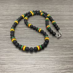 This necklace is made of 7mm round matte black onyx stone beads, 8mm green ceramic rondelle beads, 8mm red ceramic rondelle beads, and  8mm ceramic yellow rondelle beads. It has a stainless steel lobster claw style clasp and stainless steel wire guards. Available in lengths of 20-28 inches. Prices vary. matching bracelet  https://www.etsy.com/listing/1301920489/men-cameroon-flag-inspired-with-brass Black Necklaces With Colorful Oval Beads, Black Necklace With Colorful Oval Beads, Black Jewelry With Colorful Oval Beads, Casual Black Gemstone Beads, Black Necklace With Oval Spacer Beads, Casual Black Beaded Necklace With Colorful Beads, Adjustable Black Beaded Necklaces With 8mm Beads, Casual Black Jewelry With Spacer Beads, Black Beaded Necklaces With Colorful Beads For Spiritual Use