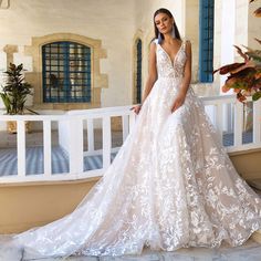 a woman in a wedding dress standing on a porch