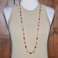 "This is an amazing hand knotted necklace that has tan bead cord with 4mm - 12mm beads in various earthtone colors and different shapes (described below) sandwiched by tiny pale gold faceted glass rondelle beads with hand knots on each side and 1/4\" space between each set of beads. The crystals lend a shimmery effect on this piece and the colors are really beautiful.  36 Inches Long Consists of: Caramel, Cream, & Brown Colored Stone Rondellle Beads (12mm). Pale Gold Oval Faceted Crystal Beads ( Adjustable Single Strand Brown Beads, Brown Gemstone Beads Long Necklace, Brown Gemstone Beaded Long Necklace, Bohemian Brown Beaded Necklaces With Oval Beads, Brown Beaded Necklace With Colorful Oval Beads, Brown Beaded Necklace With Oval Beads, Brown Beaded Necklaces With Oval Beads, Brown Single Strand Beads For Gift, Brown Single Strand Beads As Gift