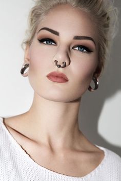 a woman with piercings on her nose