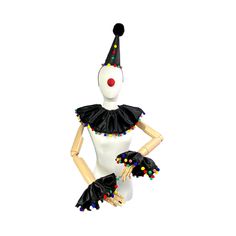 a white mannequin wearing a black dress and clown hat with multicolored beads