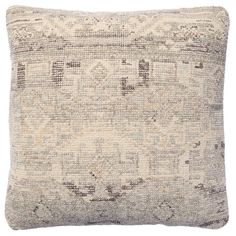 a gray and white pillow with an intricate design on the front, sitting on a white background