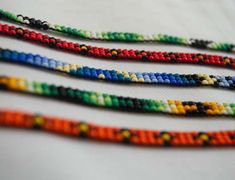 multicolored beads are lined up on a table