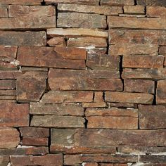 a stone wall made up of brown and white bricks