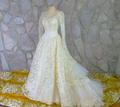 This is a vintage wedding dress from the early 50's. Cream Chantilly lace. The back has tiers of lace and net ruffles. Buttons up the back with a row of lace covered buttons into loops. Seed pearl and iridescent sequins at the bodice. There is a little darkening to the seed pearls. They can be removed or replaced if someone feels that's necessary. Dress is in excellent condition otherwise. Fits up to a 36" bust, 24" waist and full hips. Length is about 59" from top of shoulder to bottom edge. Tr Cream Chantilly, Princess Wedding Gown, Barbie Wedding, Vintage Wedding Dress, Princess Wedding, Chantilly Lace, Seed Pearl, Wedding Dresses Vintage, Covered Buttons