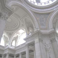 the inside of a building with columns and arches