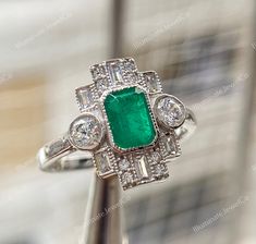 💍 DESCRIPTION OF RING 💍  - Stone Detail :- * Center Stone: Lab Diamond * Stone Shape : Emerald Cut * Stone Weight : 1.80 CT * Stone Color : Green * Side Stone : Lab Diamond * Side Stone Shape : Round Cut & Baguette Cut * Side Stone Weight : 0.64 CT * Stone Clarity : VVS1 * Stone Color : D / White - Metal Detail :- * Metal : Solid 935 Argentium Silver * Metal Finish : White Gold Finish To make your decision easier we offer * Free Shipping * Rush Order * Jewelry Box * Gift Wrapping * Engraving * Art Deco Gia Certified Emerald Ring As Gift, Gia Certified Art Deco Emerald Ring Gift, Art Deco Emerald Ring With Accent Stones For Anniversary, Emerald Diamond Engagement Ring, Emerald Ring Engagement Diamond, Green Side, Jewellery Marketing, Ring Birthstone, Metal Detail