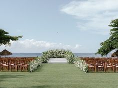 an outdoor ceremony set up with chairs and flowers