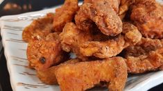 some fried food on a white and black plate