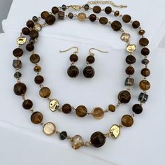 Brighten your look with this beautiful Bohemian long brown beaded necklace and earrings. This handmade jewelry set features a delightful mix of brown beads in various shapes and sizes, interspersed with gold-toned accents. Perfect for adding a splash of sunshine to your outfit, this set is ideal for festivals, beach outings, or casual wear. Embrace your free-spirited style with this vibrant and unique accessory. Length Neck size: 56cm/22inches Width: 3cm Weight:190g(Set) Earrings Weigh:5g(pair) Elegant Brown Jewelry With Gold Beads, Bohemian Brown Beads With Gold Details, Elegant Brown Necklaces With Gold Beads, Elegant Brown Beaded Necklace With Polished Beads, Elegant Brown Necklace With Gold Beads, Brown Polished Beads For Jewelry Making, Elegant Brown Polished Beaded Necklace, Elegant Brown Polished Beads, Brown Dangling Round Beads Jewelry