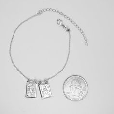 Silver plated material for lasting shine. This bracelet features two charms: the Sacred Heart of Jesus and Our Lady of Mount Carmel. Includes lobster claw clasp for secure closure. Fits most wrist sizes comfortably. Elegant blend of style and religious symbolism. Can be worn everyday or gifted as a meaningful keepsake item. The Silver-Plated Scapular Bracelet is a timeless and classic piece of Catholic jewelry. This bracelet features a fine silver plating that makes it both beautiful and durable Spiritual Everyday Nickel-free Charm Bracelet, Silver Rosary Bracelet With Charms As Gift, Adjustable Metal Charm Bracelet With Sterling Silver Clasp, Spiritual Charm Bracelet As Gift, Adjustable Silver Name Bracelet With Lobster Clasp, Spiritual Rosary Bracelet With Lobster Clasp As Gift, Adjustable Sterling Silver Charm Bracelet With Extender, Spiritual Silver Jewelry With Extender, Adjustable Sterling Silver Charm Bracelet With Lobster Clasp