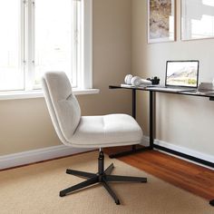 a white office chair sitting in front of a desk with a laptop computer on it