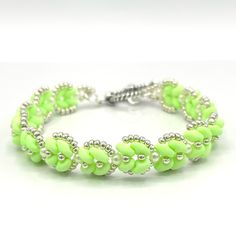 Pretty Handmade Dainty Bracelet With Lime Green Duo Beads, Tiny White Faux Pearl Beads And Silver Seed Beads Woven Into A Beautiful Delicate Design. Finished With A Silver Toned Rope Style Toggle Clasp. This Piece Is 7” Long. Party Pastel Festival Spring Neon Feminine Gifts Hand Crafted Handcrafted By Me So Each Piece Is One Of A Kind. Your Order Is Beautifully Packaged With Care And Shipped The Same Or Next Business Day. Green Beaded Bracelets With Silver Beads, Green Beaded Jubilee Bracelet, Adjustable Green Beads With Silver Accents, Pearl Beaded Bracelet, Feminine Gifts, Duo Beads, Dainty Bracelet, Delicate Design, Dainty Bracelets