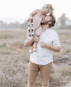 a man holding a small child in his arms