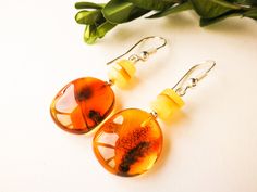 "Light honey color boho style earrings are made for cognac color amber and original style admirers. Get these bright orange color natural rectangle shape amber earrings and feel freedom with every step of the way! MATERIALS AND SIZE: Stone: 100% Natural Baltic Amber Findings: sterling silver 925 Weight: 3,4 g (0,11 oz) Bead size: 1,8 cm (0,7 in) x 1,6 cm (0,62 in) Total earring length: 4,6 cm (1,81 in) PLEASE NOTE: All our amber production is made of natural amber. Amber is an unique stone and e Handmade Baltic Amber Orange Jewelry, Honey Color, Boho Style Earrings, Cognac Color, Amber Earrings, Amber Bracelet, Natural Amber, Honey Colour, Amber Jewelry