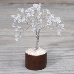 a small crystal tree sitting on top of a wooden table