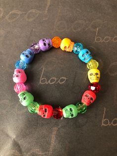 This is a Skull Beaded Bracelet. It would make a great gift for Halloween. It would make a great addition to your Halloween costume.  It has blue, pink, green, red, yellow, turquoise, and orange skull beads. It has 8mm faceted beads in purple, blue, pink, green, red, yellow, turquoise, and orange. It was made with .8mm sturdy stretch string. I tie it several times to prevent breakage. It fits girls ages 5-8. It stretches to fit on the wrist. All items are ready to be shipped I do combined shippi Adjustable Red Beaded Bracelets For Halloween, Multicolor Novelty Bracelets For Halloween, Adjustable Multicolor Beaded Bracelets For Halloween, Handmade Multicolor Bracelets For Halloween, Halloween Multicolor Beaded Bracelets, Fun Adjustable Jewelry For Halloween, Fun Multicolor Halloween Jewelry, Party Novelty Beaded Bracelets, Halloween Novelty Multicolor Beaded Bracelets