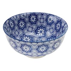 a blue and white bowl sitting on top of a table