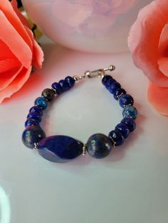 Beautiful bracelet can be wear on any occasion. Is been made with 3 Lapis lazuli stone at the center  2 10mm round 1 20x12mm swirl  4 6mm round Agate 13 6mm rondelle Agate 10 Star spacer sterling silver  1 Toggle clasp Sterling silver  This is a unique bracelet created by me. Any questions please contact me. Sapphire Gemstone Beads Bracelet In Lapis Lazuli, Blue Lapis Lazuli Gemstone Beaded Bracelet, Oval Blue Gemstone Bracelets, Blue Lapis Lazuli Bracelets With Polished Beads, Blue Lapis Lazuli Bracelets With Natural Stones, Sapphire Lapis Lazuli Beaded Bracelet With Natural Stones, Blue Agate Jewelry With Polished Beads, Blue Oval Sterling Silver Bracelet Gift, Oval Blue Sterling Silver Bracelet As Gift