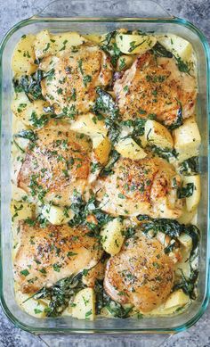 chicken, potatoes and spinach casserole in a glass dish on a table