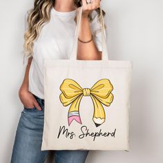 This 100% cotton Personalized Teacher bag comes in one size - 15" x 16"- perfect for everyday wear. While the canvas material of this Custom Teacher Tote will show off your designs in great colors, it's durable and will last for years. The gift for teacher bag features 20" handles (made from the same canvas), making it easy to carry even with all the teacher's essentials!  .: 100% cotton canvas .: Heavy fabric (12 oz/yd² (406.9 g/m .: Sewn-in label All teacher appreciation gifts are made to order! We do not accept returns, but if there are any issues with your product, then please reach out so we can make things right! Yellow Canvas Bag As Gift, Back To School Gift Canvas Tote Bag, Mother's Day Cotton Canvas Bag For Daily Use, Yellow Bags For Back To School Gift, White Cotton Canvas Bag For Back To School, Daily Use Cotton Canvas Bag For Mother's Day, Mother's Day Cotton Canvas Bag, Rectangular Cotton Canvas Bag For Back To School, Yellow Cotton Canvas Gift Bag