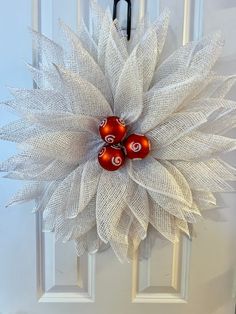 a white door with two red and white decorations on it's front door handle