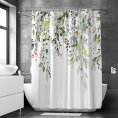 a shower curtain with leaves on it in a bathroom