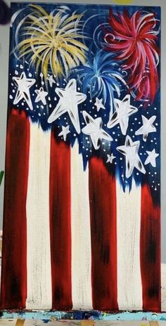 an american flag painting with stars and fireworks in the sky on it's side