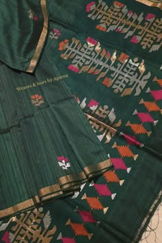 two green cloths with designs on them and one has a gold border around the edges