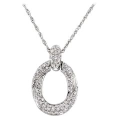 This necklace features an oval shape 18K white gold pendant encrusted in 0.55 carats of G-H VS diamonds. 6 grams of gold. Chain length is approximately 9 inches. Made in Italy. Luxury White Gold Diamond Necklace With Round Pendant, Timeless White Gold Oval Pendant Diamond Necklace, Timeless Oval Pendant Diamond Necklace With Accents, Dazzling Platinum Oval Necklaces, Oval Pave Setting Necklaces, White Gold Diamond Necklace With Brilliant Cut Oval Pendant, Formal Oval Diamond Necklace In Platinum, Formal Platinum Diamond Necklace With Oval Shape, Formal Oval Platinum Diamond Necklace