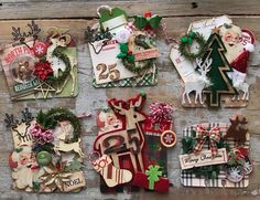 several christmas cards are arranged on a wooden surface