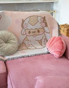 a pink couch with a pillow on top of it