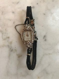 "A lovely antique ladies Hamilton wrist watch which is a fresh estate find. Very nice original condition & seems to be in working order when wound. Impressed on reverse 14k white gold with diamond accents on each side of the watch face. Very dainty, petite & elegant. Measures: 6.5\" length" Handmade Luxury Vintage Watch Accessories, Hamilton Art, Dope Jewelry, Jewelry Lookbook, Funky Jewelry, Gull, Jewelry Inspo, Dream Jewelry, Pretty Jewellery