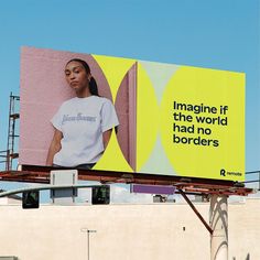 a billboard with an image of a woman in white shirt on the side of a building