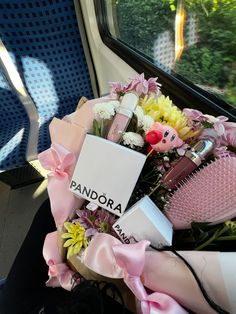 a bouquet of flowers sitting on top of a train seat