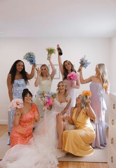 the bridesmaids are all holding bouquets in their hands and posing for a photo