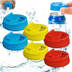 four different colored water bottles being held by someone's hand