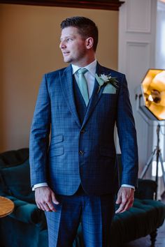 a man in a blue suit and green tie