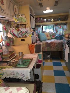 the inside of a camper with lots of furniture and decor on it's walls