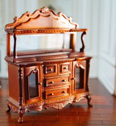 a wooden dresser sitting on top of a hard wood floor