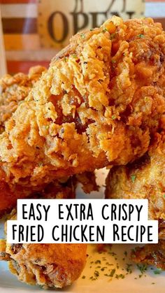 fried chicken on a plate with the words easy extra crispy fried chicken recipe