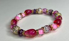 We added the PERFECT mix of Pink on this one that's why she's the Prettiest of them All! Infused with beautiful multi colored India Imported Sapphire crystals, this beautifully curated style has an elegant touch but is sure to make an IMPACT when worn. Add this flavorful style to any ensemble today. * Handmade Item* Consists of 1 Bracelet* Approximately 7.5-8 inches in diameter* Materials: Semi precious stones, Hematite, Metal, AAA Grade Sapphire, Glass* Please allow 3-5 business days before shi Elegant Multicolor Beaded Bracelets For Festive Occasions, Elegant Pink Beaded Bracelets For Festive Occasions, Multicolor Rhinestone Beaded Bracelets For Party, Multicolor Beaded Bracelets With Rhinestones For Party, Make An Impact, Kids Earrings, Semi Precious Stones, Curator Style, Earring Necklace